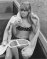 One of four photos of Wendy Richard sitting in a boat