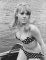 Wendy Richard, wearing a polka dot bikini, sits in a boat