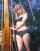 Wendy Richard stands in a polkadot bikini on the deck of a boat