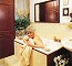 Wendy Richard, still in the bath, holding a towel and smiling