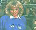 Wendy Richard, dressed in jeans and a blue sweatshirt, sits surrounded by her frog
				 collection